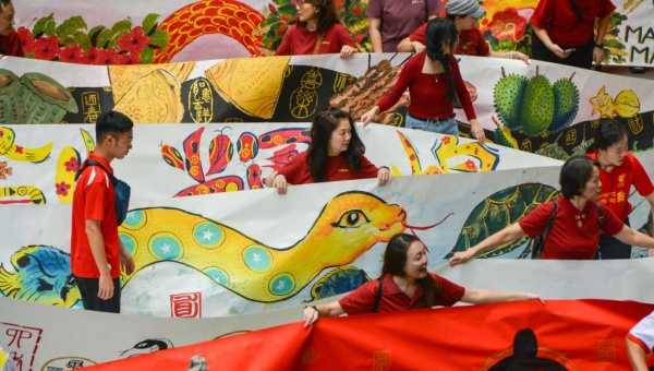 Students participate in creation of scroll to celebrate upcoming Year of Snake in Malaysia