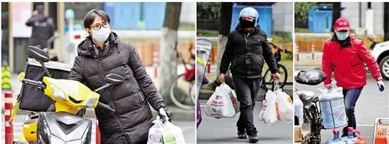 Takeout and express deliverers rush from one street to another in Hangzhou, Zhejiang province, in recent days.jpg
