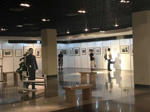 Visitors look at the photos at the exhibition commemorating the 120th anniversary of the birth of the People’s Republic of China's first premier, Zhou Enlai.jpg