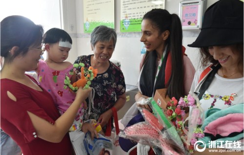 Two Iraqi students from Zhejiang University with the collection of gifts they gave to children in a local children’s hospital in Hangzhou.jpg