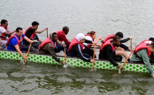 International students race dragon boats in Jinhua