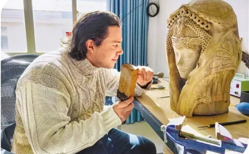 Frenchman bridges cultures through woodcarving