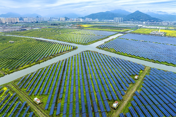 An oil painting of a bountiful harvest and clean energy