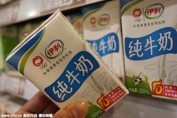 Chinese customer shops for a carton of Yili pure milk at a supermarket in Xuchang city, Central China's Hunan province, Nov 16, 2014..jpeg