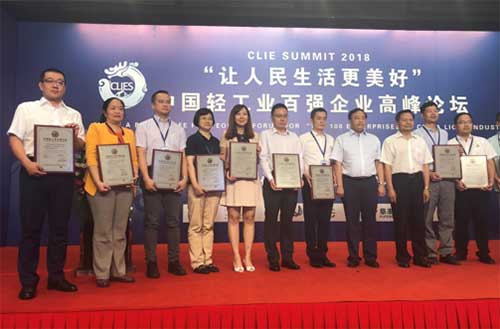 Luo Yan (1st from left), vice-president of Yili Group, joins representatives of awarded enterprises onstage at the Forum for Top 100 Enterprises in China Light Industry in Beijing June 20.jpg