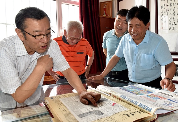 1529917072666077809.jpg Lian Ji, left, reads articles from the Inner Mongolian archives accompanied by Jin Feng, second from left, and Yun Guohong, right, June 21..jpg