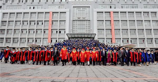 Graduates and staff pose for a photograph after the graduation ceremony held at IMNU on July 3..jpg