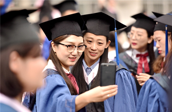 Graduates take a selfie to mark their graduation from IMNU, July 3..jpg