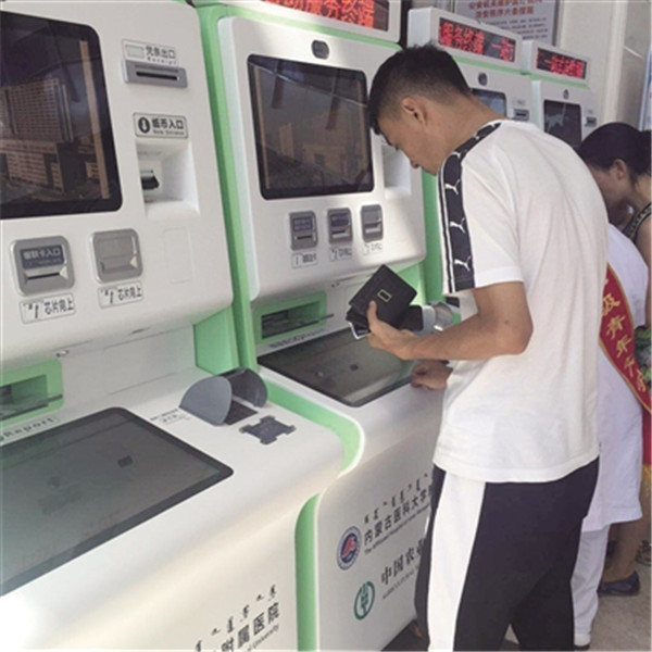 A patient pay the medical bills through a self-service machine at the Affiliated Hospital of Inner Mongolia Medical University in Hohhot, North China’s Inner Mongolia autonomous region.jpg