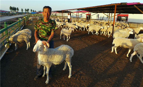 local officials helped him get a bank loan of 180,000 yuan and build a pen