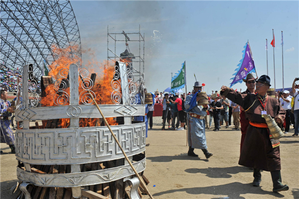 Inner Mongolians burn a sacrificial ritual honoring various gods at the opening ceremony of the 24th Tourism Naadam Festival 