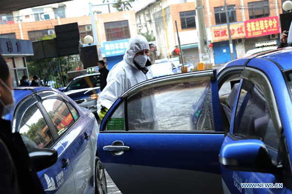 A worker disinfects a taxi at a service point in Wuxi, East China's Jiangsu province, Jan 26, 2020.jpg
