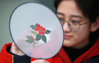 Students study traditional Chinese fan paintings in Yangzhou