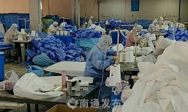 Workers are hard at work in a workshop of Jiangsu Guangda Medical Materials Co, a Hai’an-based company that produces surgical masks and protective suits.jpg