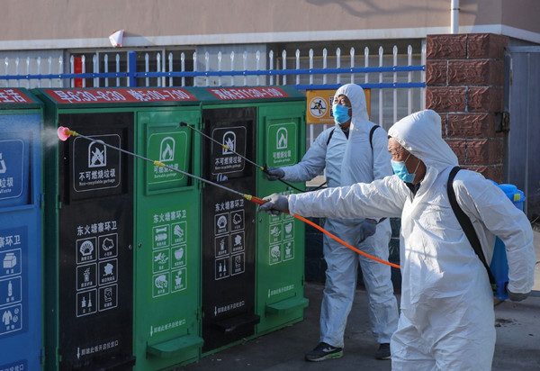 Villagers spray dustbins with disinfectant as part of the measures to prevent the novel coronavirus epidemic in Rongcheng, Shandong province, Jan 30, 2020.jpg