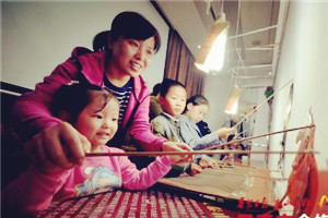 Youngsters play with puppets in Tai'an