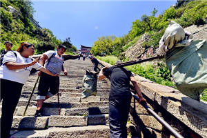 Porters see a steep drop on Taishan Mountain