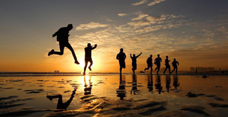 College students run on beach in Yantai