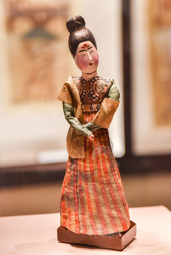 IC-A painted wooden figure with silk garments, dating back to the Tang Dynasty, vividly depicts a female dancer. It is in the permanent collection of the Xinjiang Uygur Autonomous Region Museum..jpeg