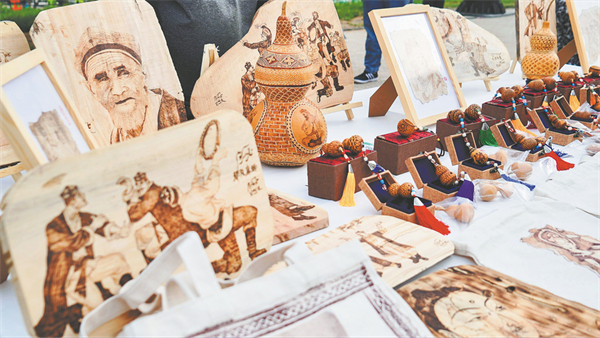A stand showcases specialty products from the Xinjiang Uygur autonomous region, at the award ceremony of the 2023 Xinjiang Tour Guide (Docent) Competition. CHINA DAILY.jpg
