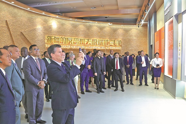 1-Delegates visit an exhibition in Urumqi showcasing Xinjiang's efforts to combat terrorism and extremism. ZHAO CHENJIE XINHUA.jpg