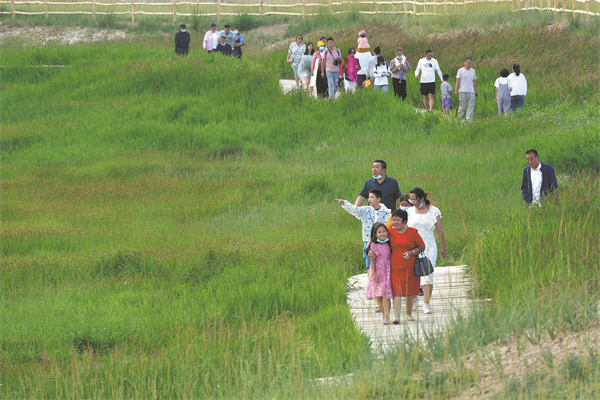 Visitors enjoy the wetland in Barkol Kazakh autonomous county, Hami, Xinjiang..jpg