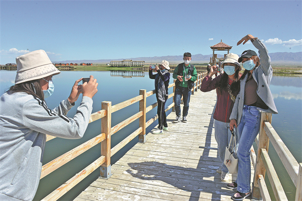 Visitors pose at the Gaojiahu Wetland Scenic Area in Barkol Kazakh autonomous county, Hami, Xinjiang..jpg