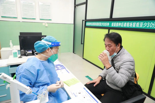 A resident receives inhales the nebulised vaccine..png