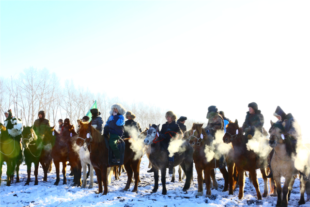 Horse racing on snowy Hulunbuir grasslands