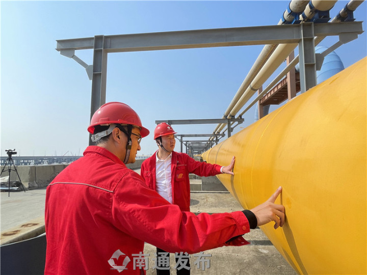 workers examine the construction of pipeline bridge at yangkou