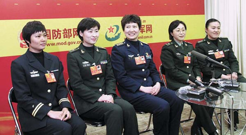 Liu Yang (second from left), China's first female astronaut and an NPC deputy, joins four other military NPC deputies in a group interview on Thursday. [Peng Hongxia for China Daily]